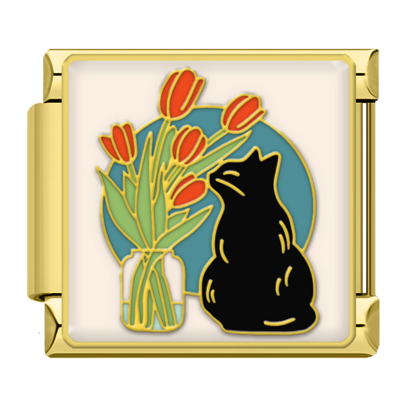 Black cat smelling flowers