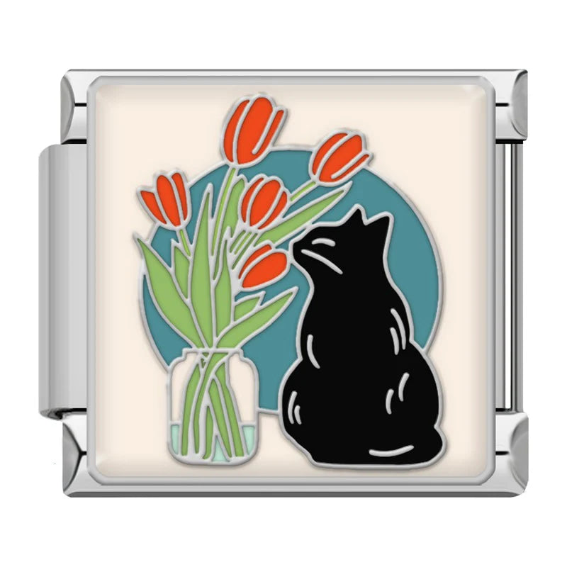 Black cat smelling flowers